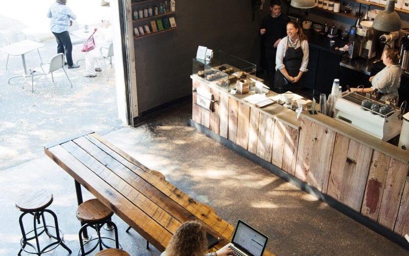The reclaimed-wood cafe and communal table at Ceremony Coffee Roasters in Mount Vernon