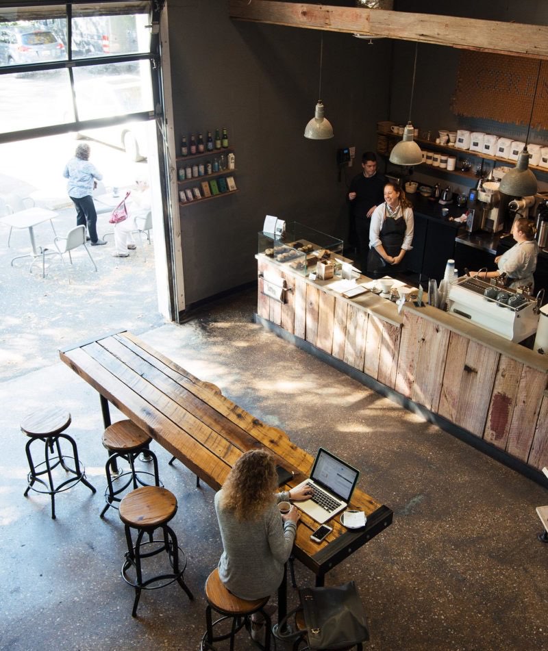 The reclaimed-wood cafe and communal table at Ceremony Coffee Roasters in Mount Vernon