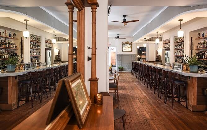 The long marble bar and warm woodwork at Dutch Courage in Old Goucher