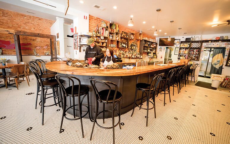 The curved oyster bar and penny-tile floor at Dylan's Oyster Cellar in Hampden