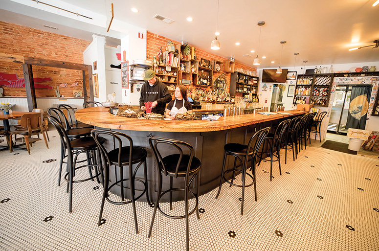 The curved oyster bar and penny-tile floor at Dylan's Oyster Cellar in Hampden