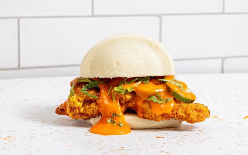 Ekiben's Neighborhood Bird sandwich, fried chicken and herbs in a steamed bun