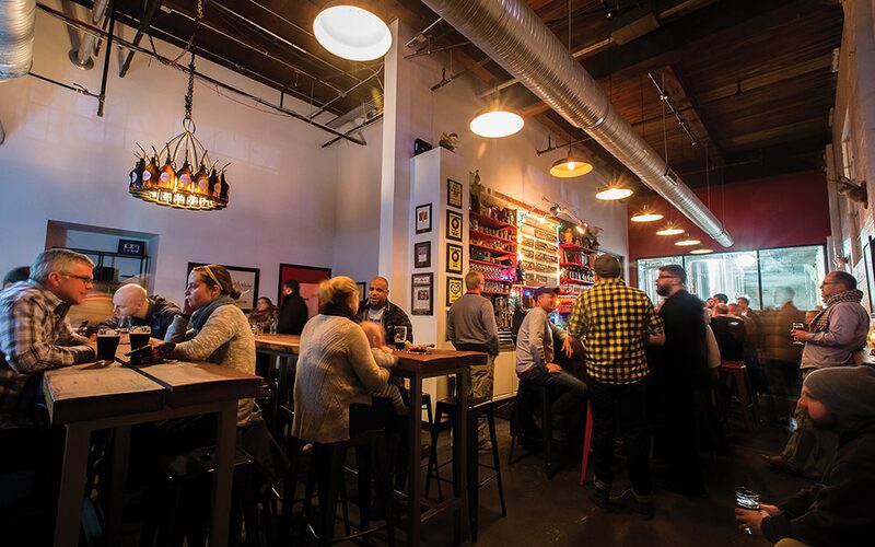 The lively taproom with a beer-bottle chandelier at Union Craft Brewing in Medfield