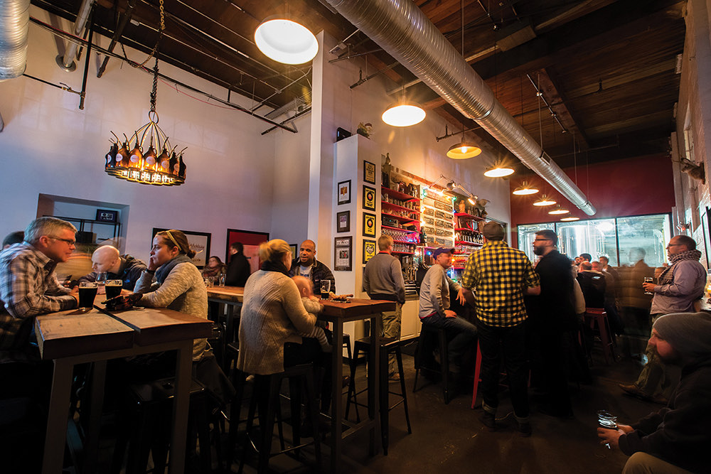 The lively taproom with a beer-bottle chandelier at Union Craft Brewing in Medfield